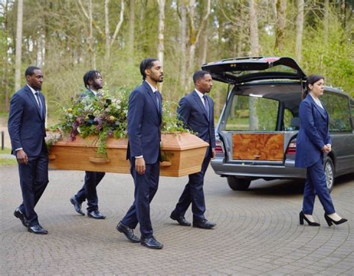 Who are the black guys carrying a coffin?